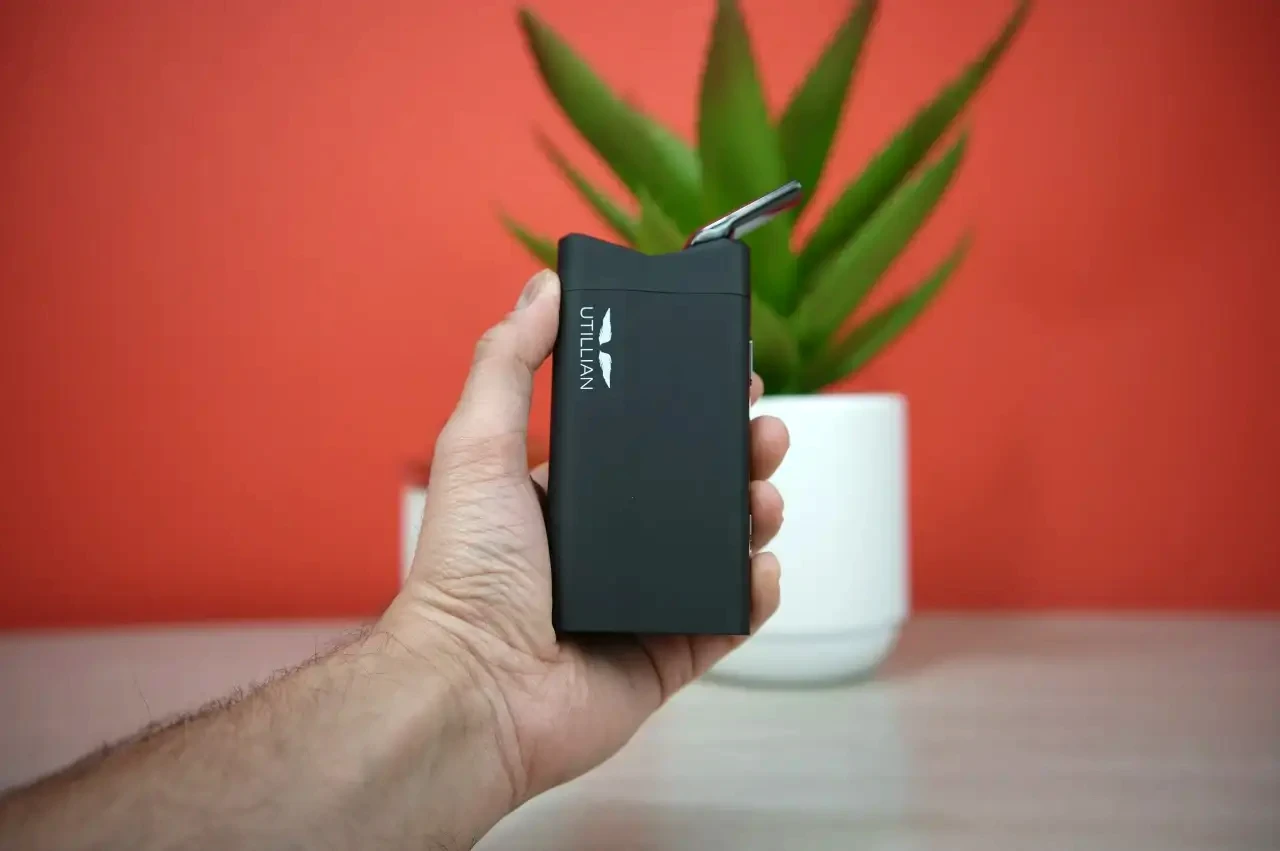 Testing the portability and size of the Utillian 850 vaporizer by holding it in hand